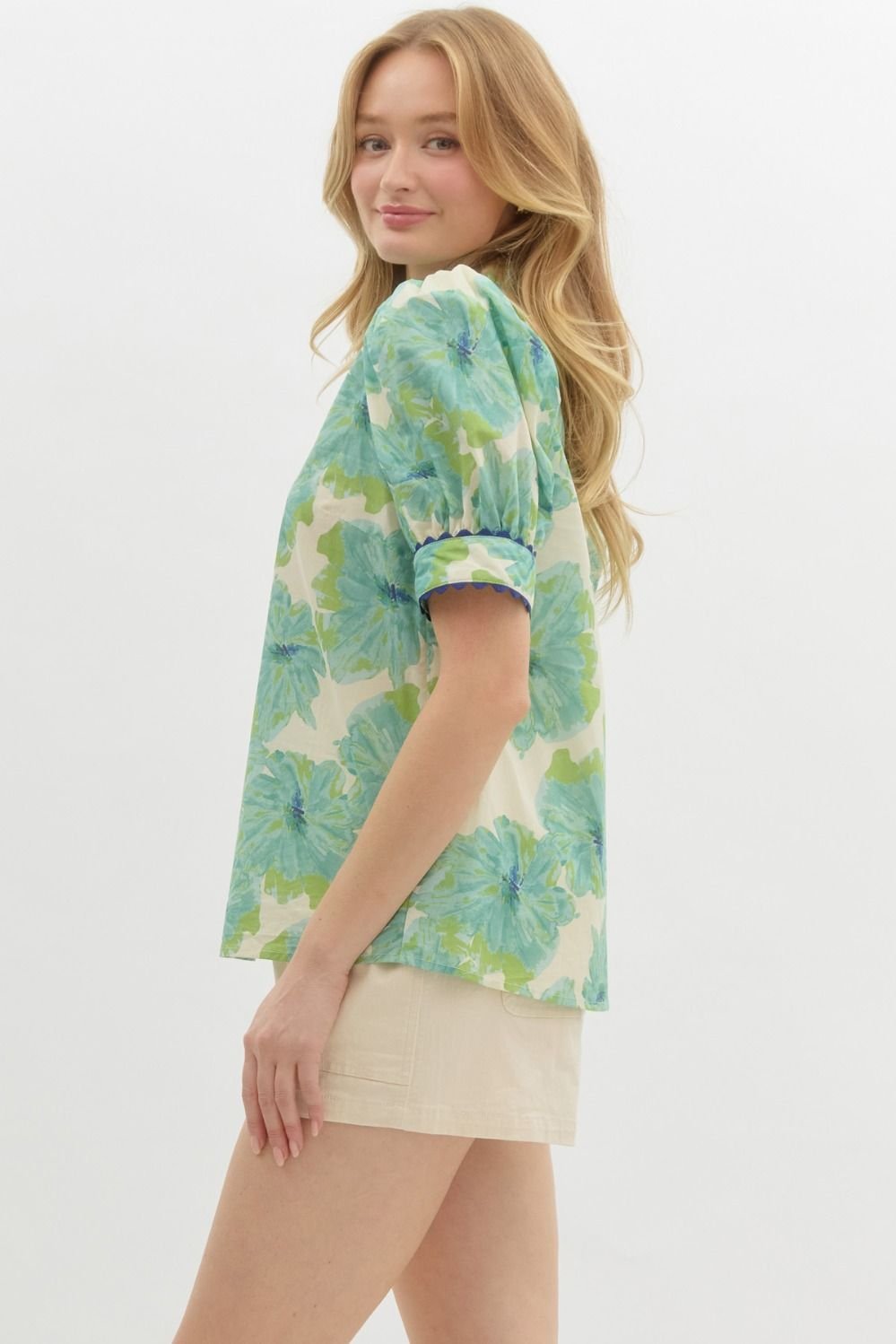 Green floral top with neck and sleeve detail, perfect for coastal boutique clothing and beach dresses.
