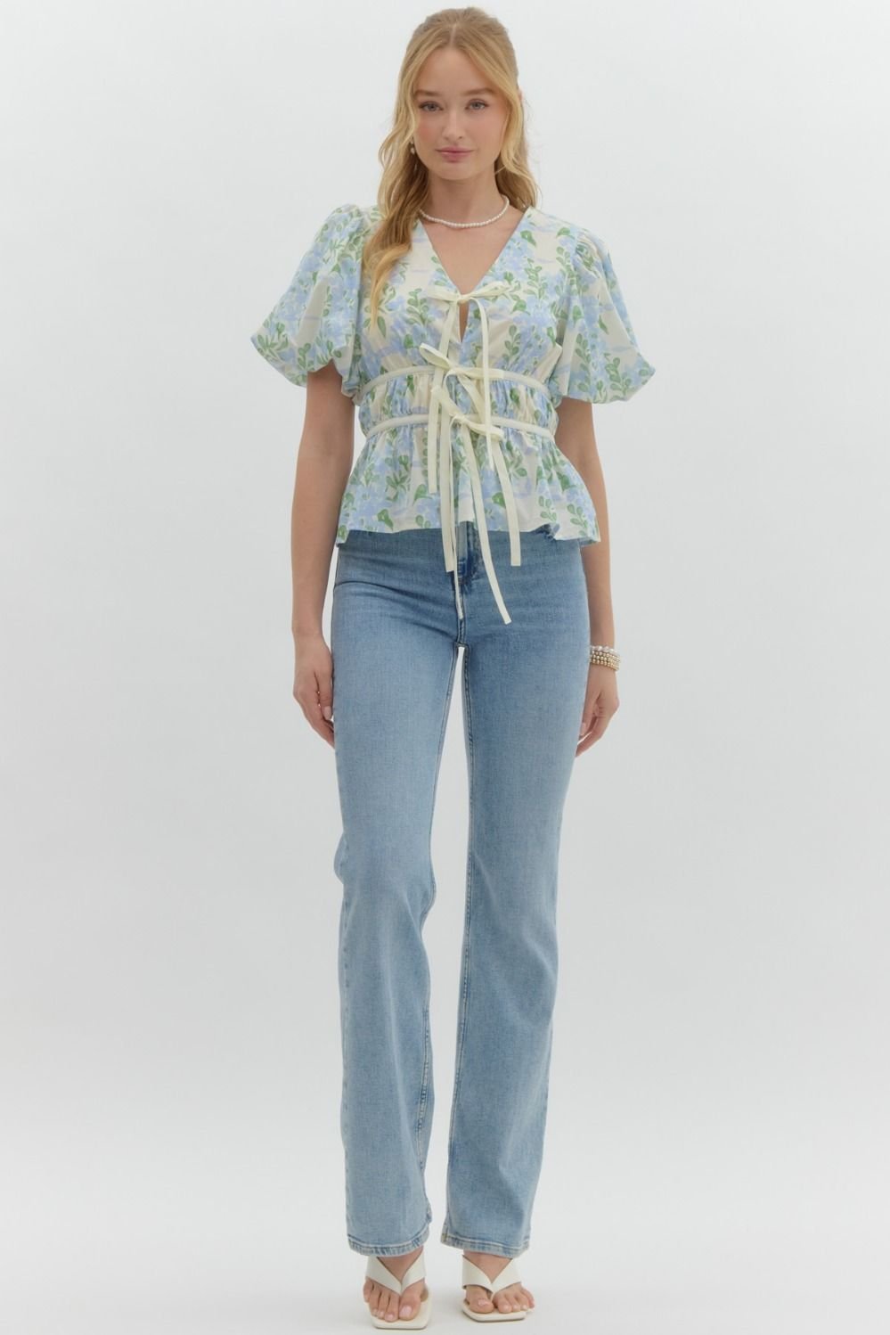 Blue floral print tie-front top, perfect for coastal boutique clothing and tropical vacation outfits. Stylish women's top and gifting.