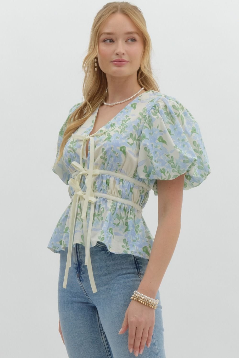 Blue floral print tie-front top, perfect for coastal boutique clothing and stylish summer outfits. Ideal for Port Aransas beach vibes.