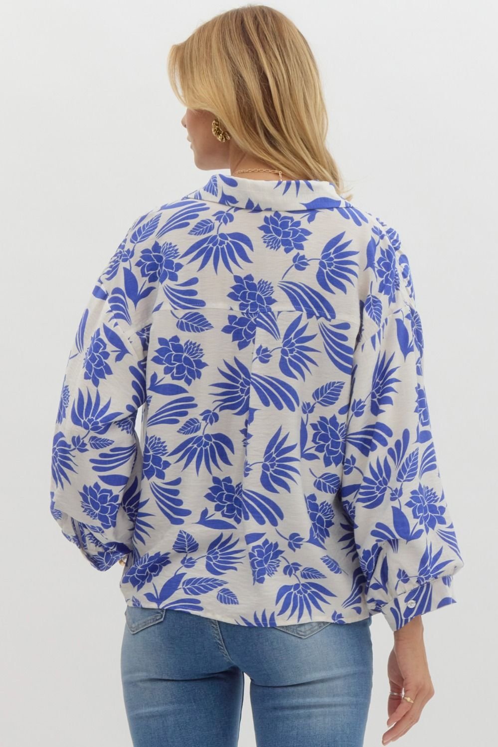 Back view of a stylish royal blue and cream floral button-down top, perfect for coastal boutique clothing and tropical vacations.