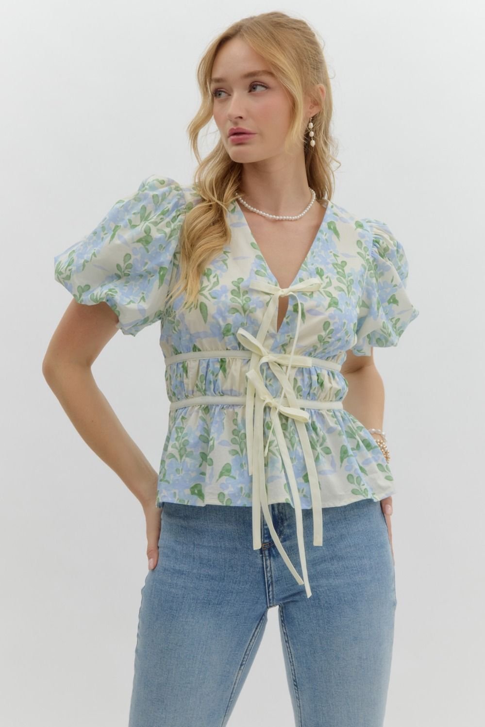Blue floral print tie-front top from a Port Aransas boutique, perfect for stylish coastal vacation outfits and curvy women's fashion.