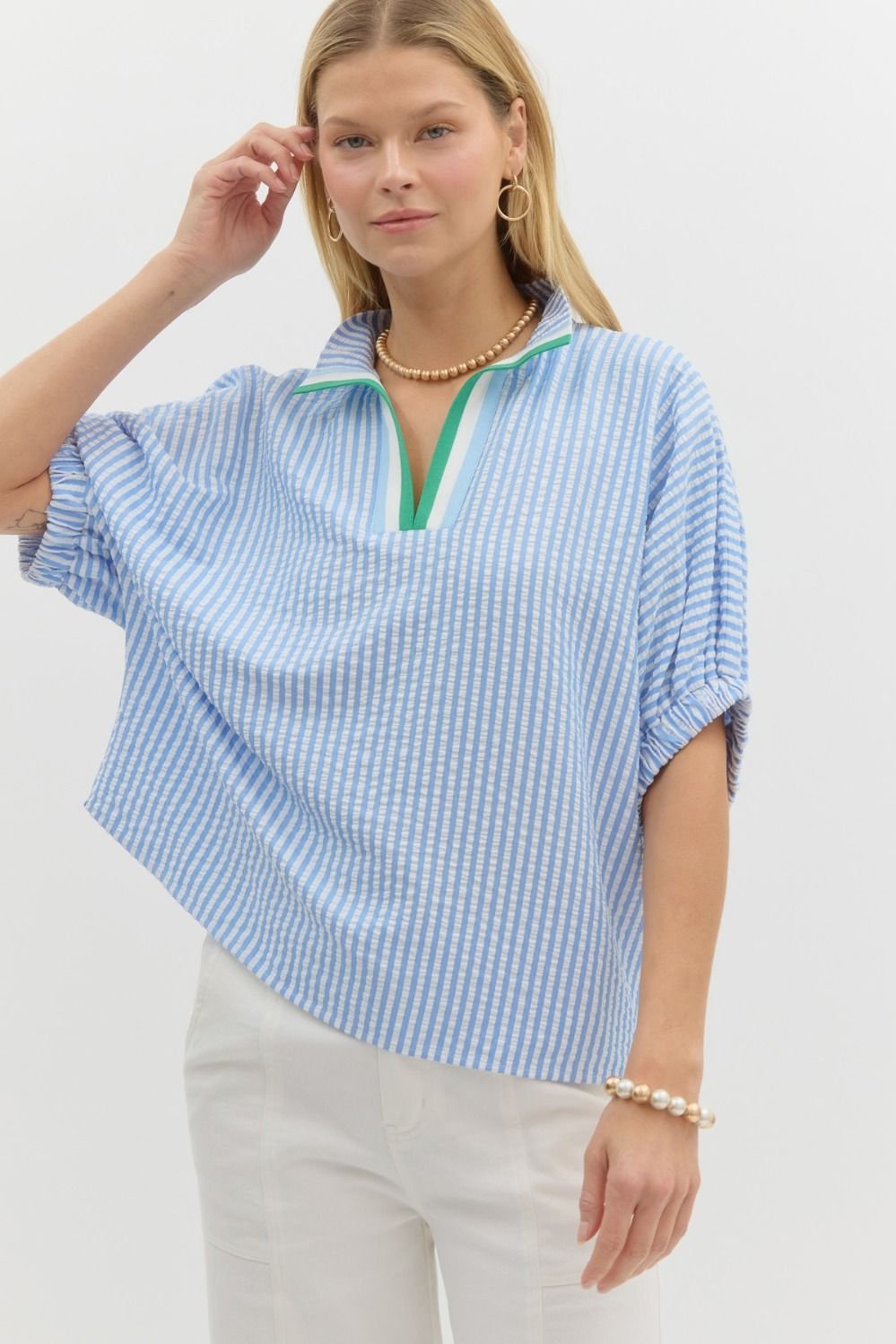 Stylish blue and white striped top with green detail, perfect for coastal boutique clothing and tropical vacation dresses.