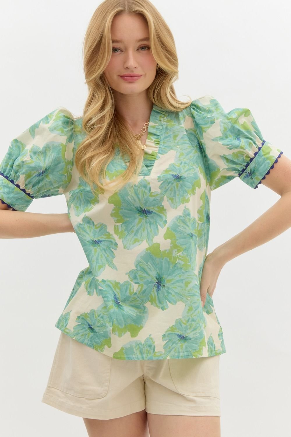 Green floral top with neck and sleeve detail, perfect for coastal boutique clothing and tropical vacation dresses.