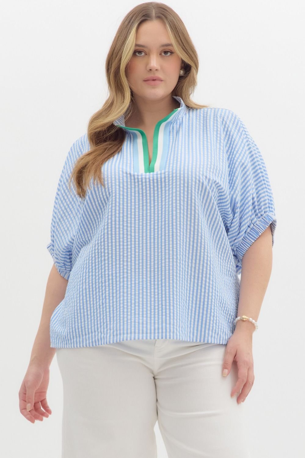 Stylish plus-size blue and white striped top with green detail from a coastal boutique, perfect for chic day-to-day wear.