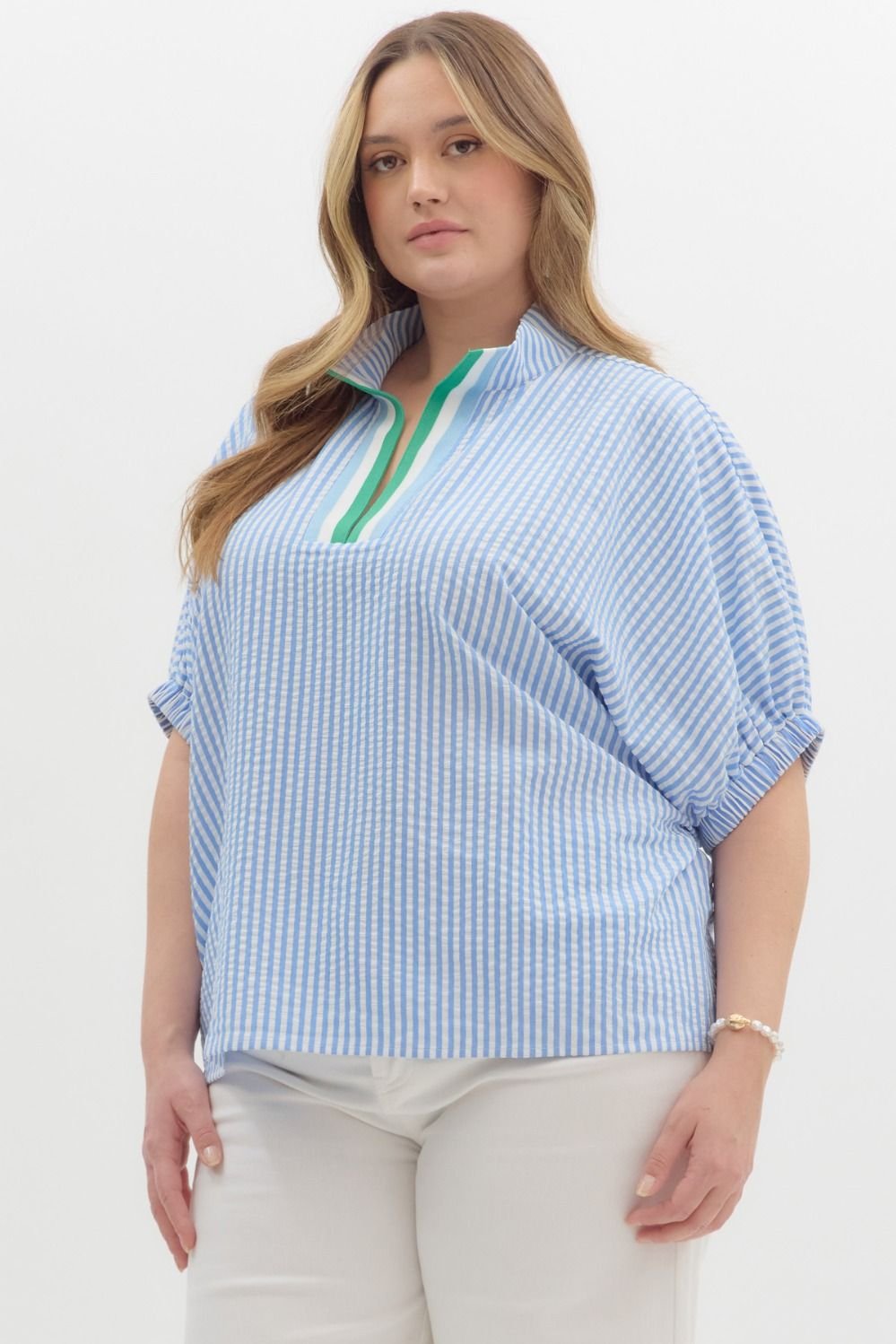 Plus-size blue and white striped top with green detail, perfect for casual chic style at coastal boutiques.
