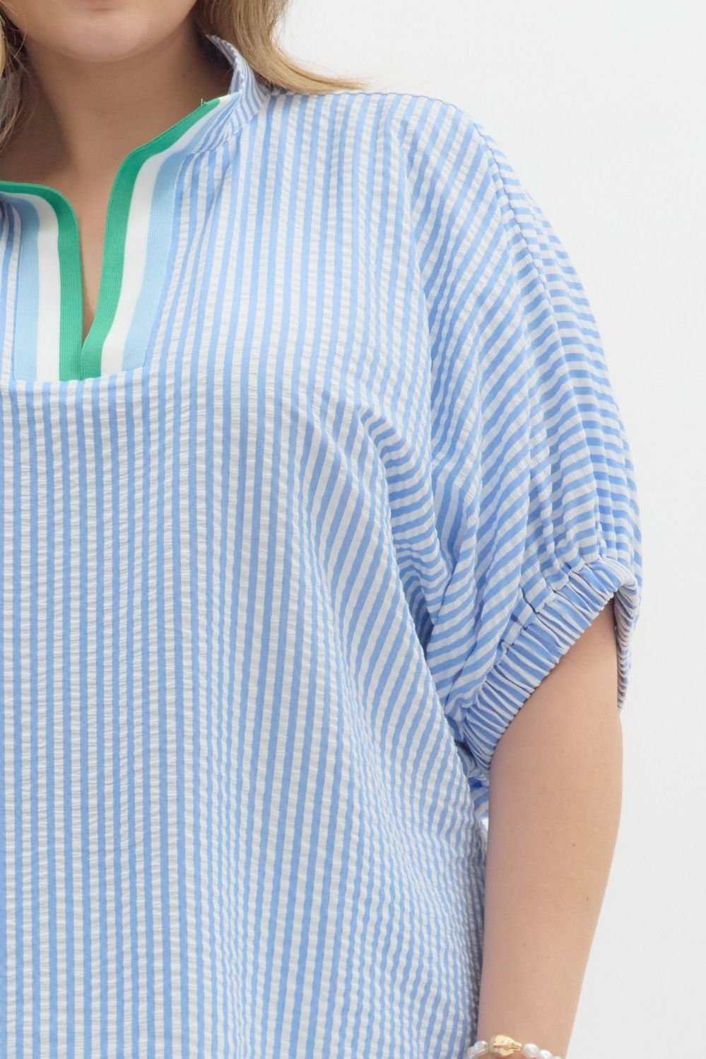 Casual chic blue and white striped plus-size top with green detail, ideal for coastal boutique clothing and tropical vacation dresses.