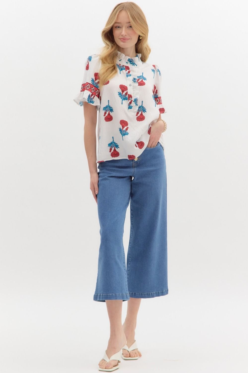 Floral print top paired with wide-leg jeans, perfect for casual outings, from a Port Aransas coastal boutique.