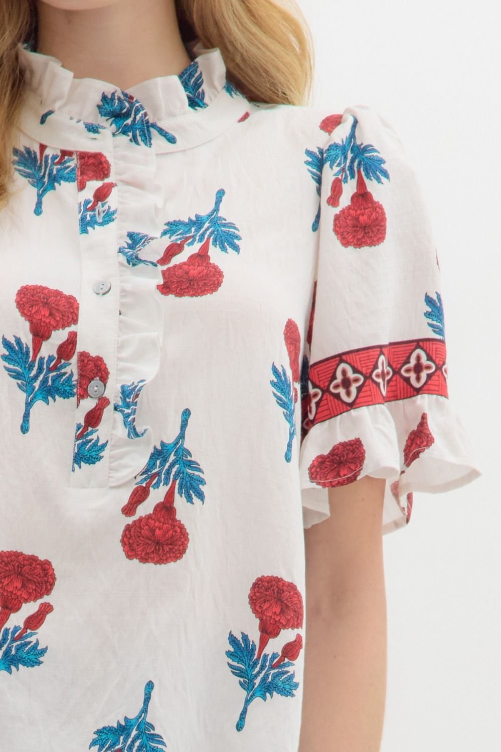 Floral print top with banded sleeves, perfect for coastal boutique clothing and casual beach outfits.