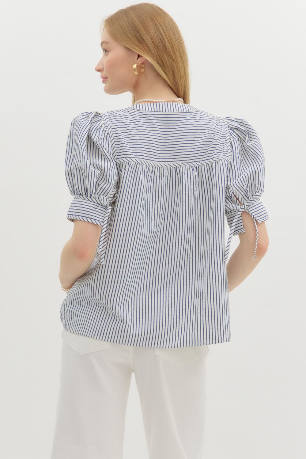 Blue striped structured shoulder top, perfect for warm weather, a chic addition to coastal boutique clothing collections.