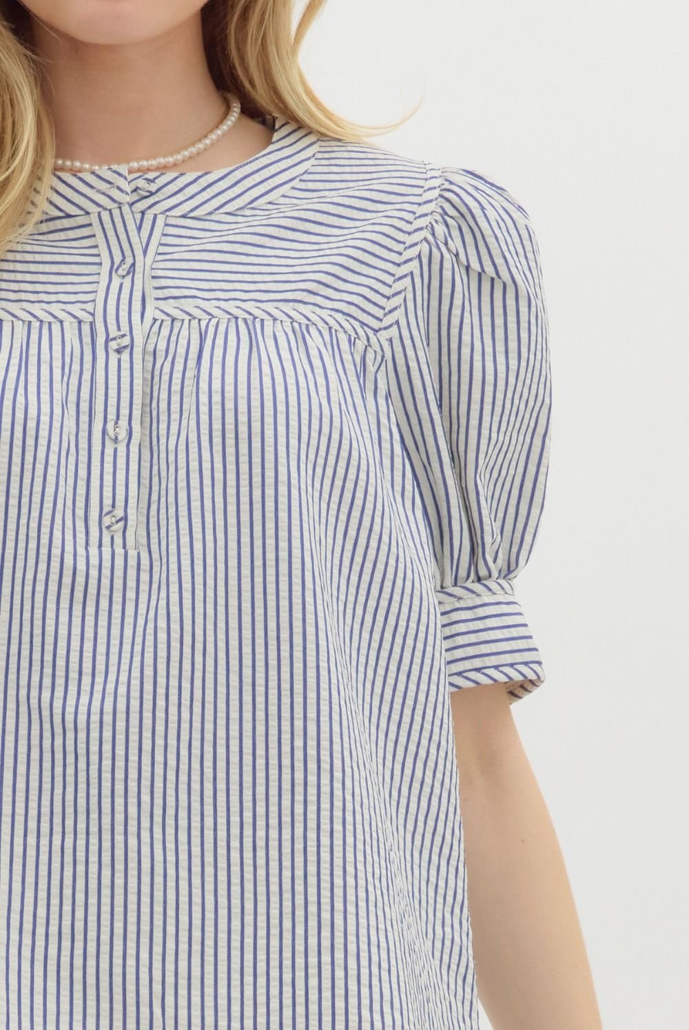 Stylish blue striped structured top with puff sleeves, perfect for coastal boutique clothing and warm weather outfits.