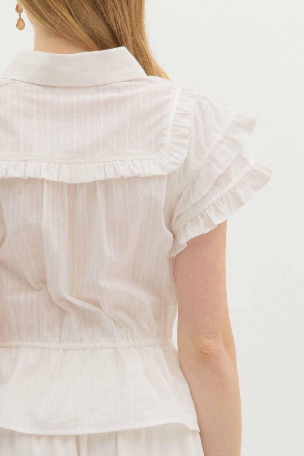 Back view of a romantic off-white top with tiered flutter sleeves, perfect for coastal boutique clothing and tropical vacation dresses.