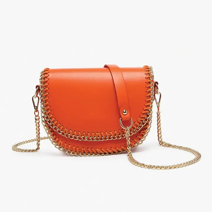 Izzy Crossbody handbag in vibrant orange with gold chain trim, perfect for coastal boutique clothing and stylish summer outfits.