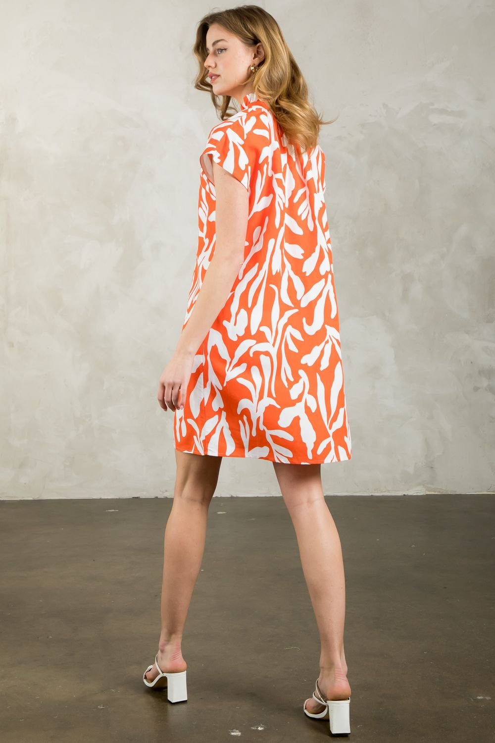 Model showcasing THML Orange You Wonderful Dress with a vibrant print, perfect for summer outfits Texas and coastal fashion boutique.