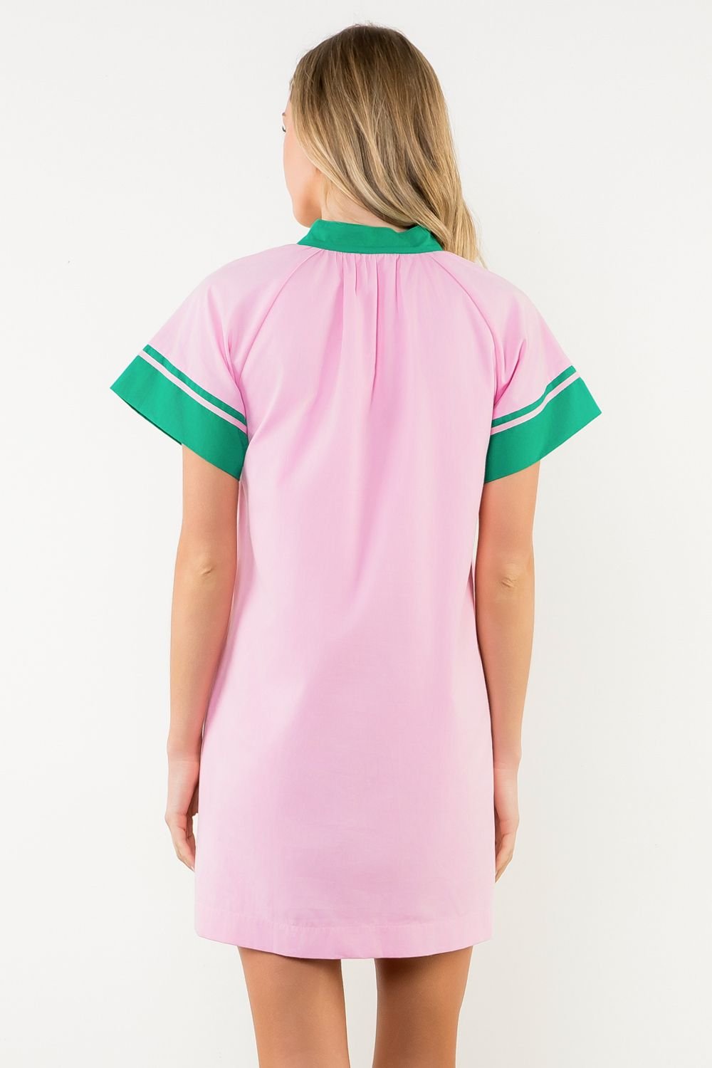 Back view of Annie Dress featuring pink body and green contrast trim, perfect for coastal boutique clothing and beach dresses.