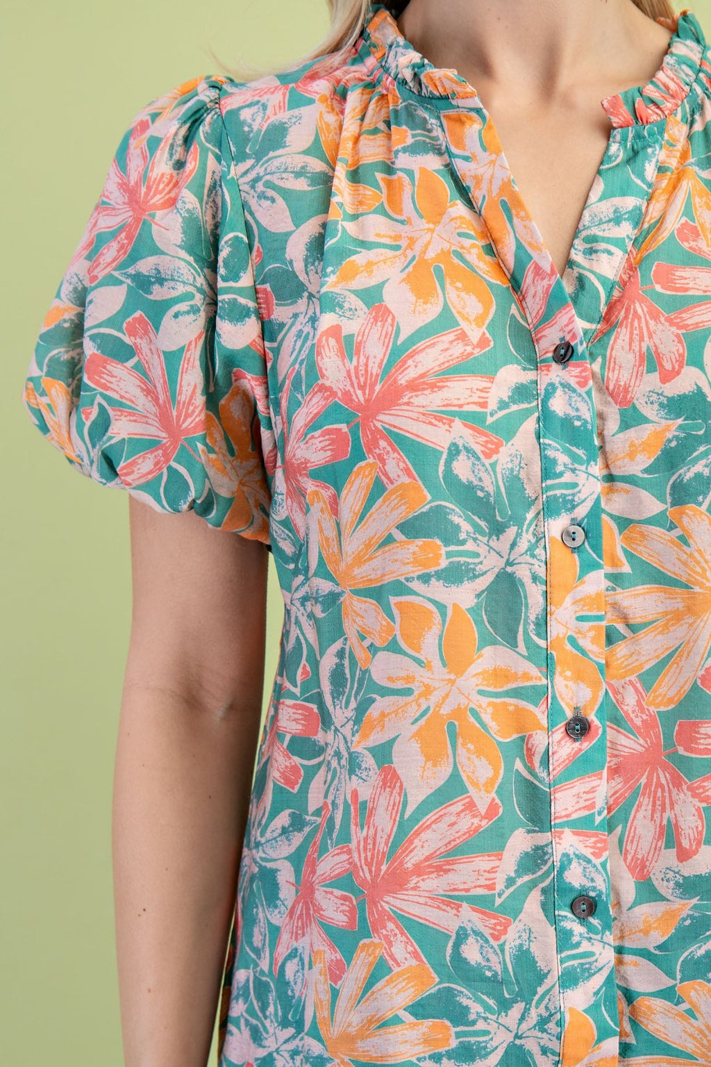 Floral green and orange button down top from Port Aransas boutique, perfect for spring and pairing with white denim.