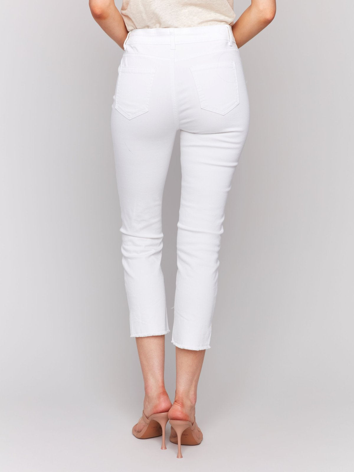 White Pants with Gold Details at Pocket and Hem, stylish women’s clothing from Raggdoll Boutique.