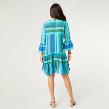 Back view of COCO + CARMEN Milena Ruffle Sleeve Tunic Dress in vibrant colors, perfect for beach and tropical vacations.