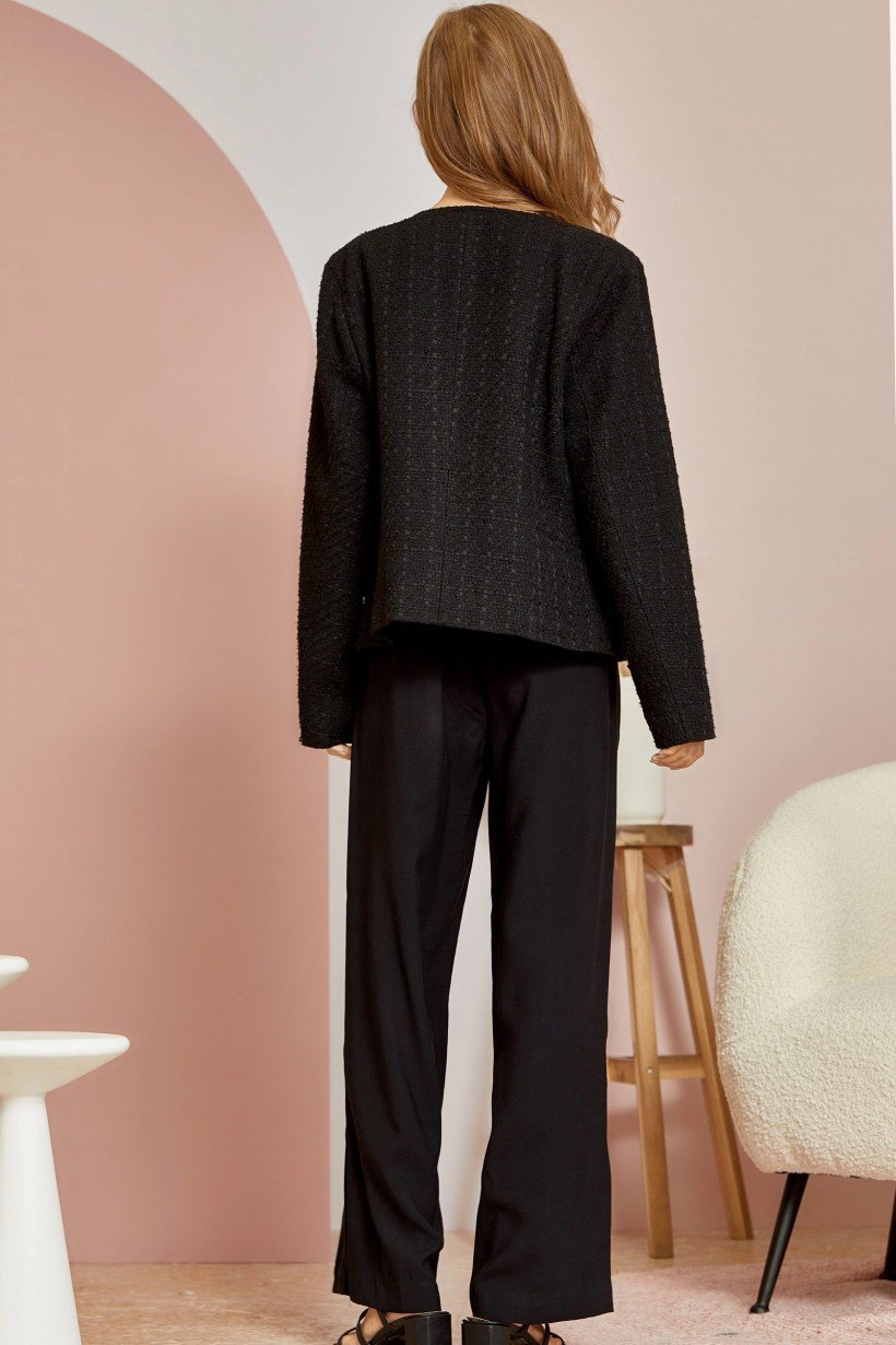 BLACK TWEED JACKET WITH PEARL BUTTONS worn with stylish black pants, showcasing trendy coastal fashion from Raggdoll Boutique.
