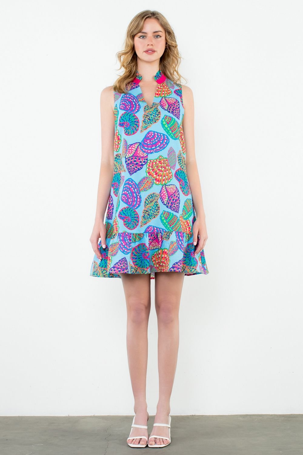 Jordyn Dress in vibrant shell print, perfect for coastal boutique clothing and tropical vacation dresses. Flirty ruffle hem.