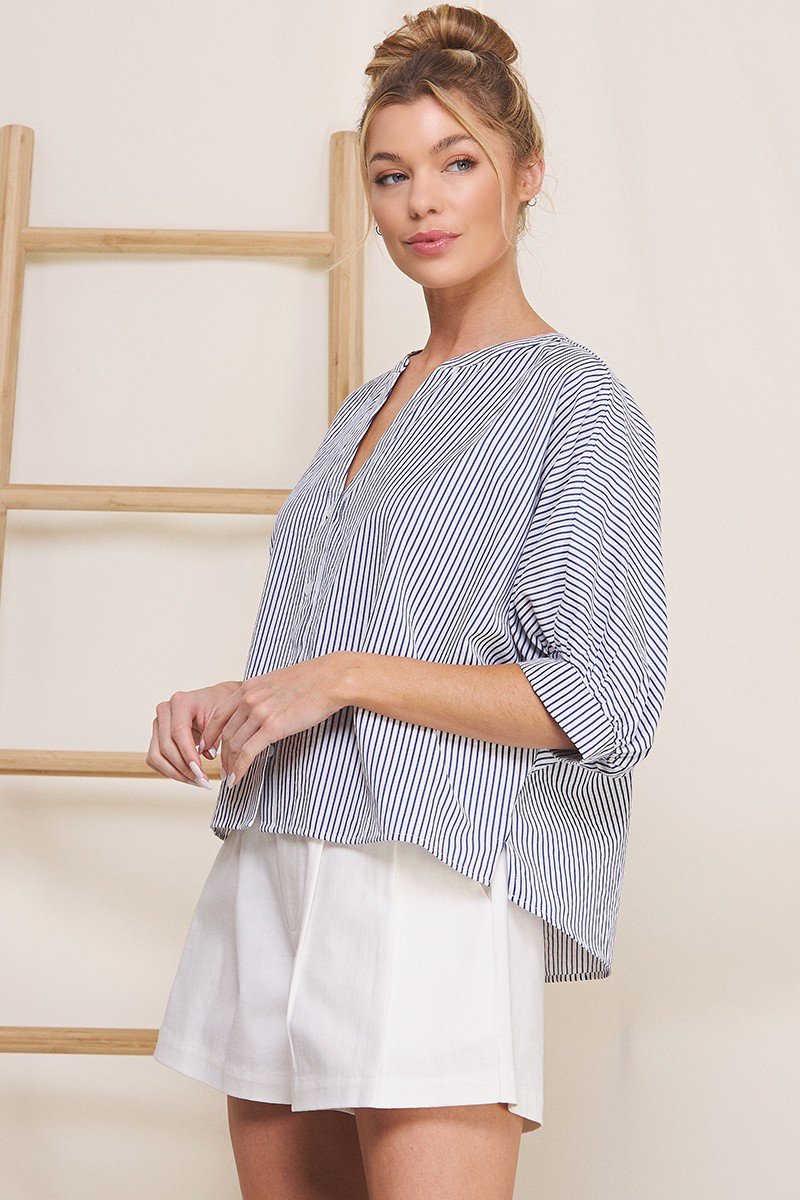 Navy pinstripe seersucker blouse with button front and dolman sleeves from a Port Aransas boutique. Stylish and breathable.