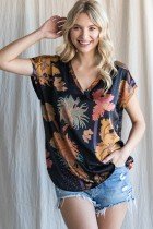 Model wearing BLACK SATIN PRINT TOP from Raggdoll Boutique, styled with casual shorts for a trendy coastal look.