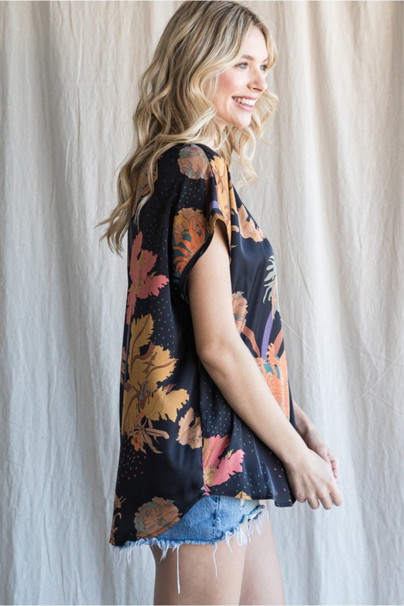 Side view of a woman wearing a BLACK PRINT TOP from Raggdoll Boutique, showcasing trendy coastal style.