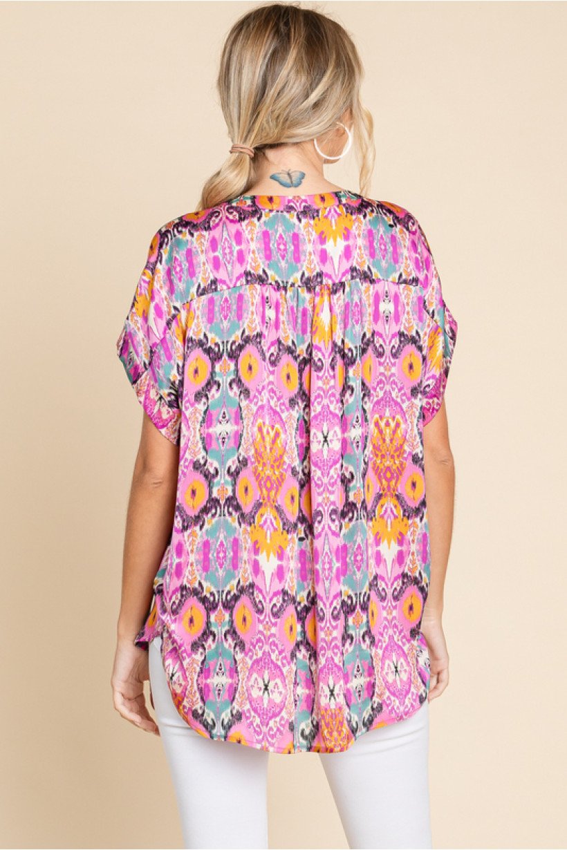 Stylish woman wearing ORCHID MIX TOP from Raggdoll Boutique, showcasing trendy coastal style in Port Aransas.