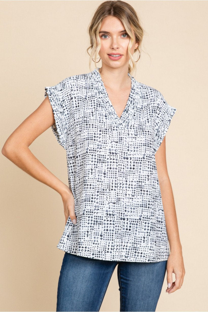OFF WHITE V-NECK TOP  (BLACK CIRCLE PATTERN) from Raggdoll Boutique, perfect for trendy coastal style in Port Aransas.