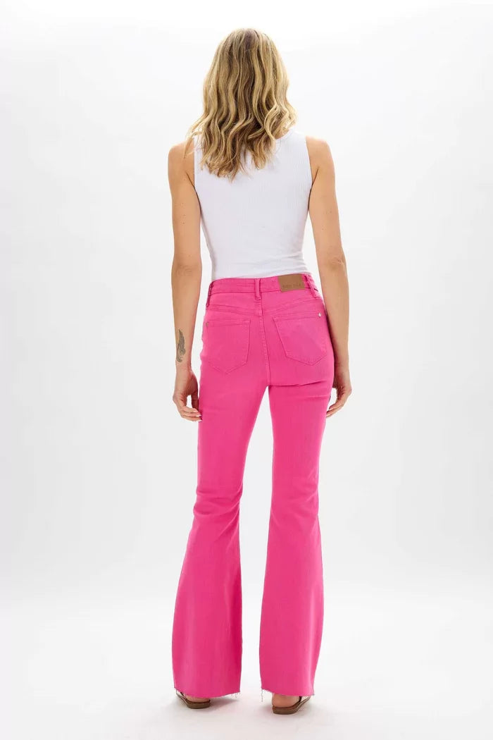 Woman wearing JUDY BLUE HOT PINK FRAYED FLARE JEAN from Raggdoll Boutique, perfect for trendy coastal style.