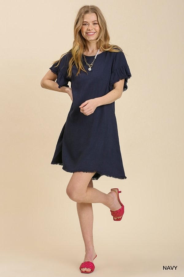 Navy dress with cut-out back detail, perfect for coastal boutique clothing and tropical vacations, features stylish design and feminine flair.