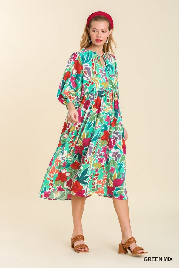 Woman showcasing GREEN MULTI DRESS from Raggdoll Boutique, featuring vibrant floral patterns perfect for summer outfits Texas.