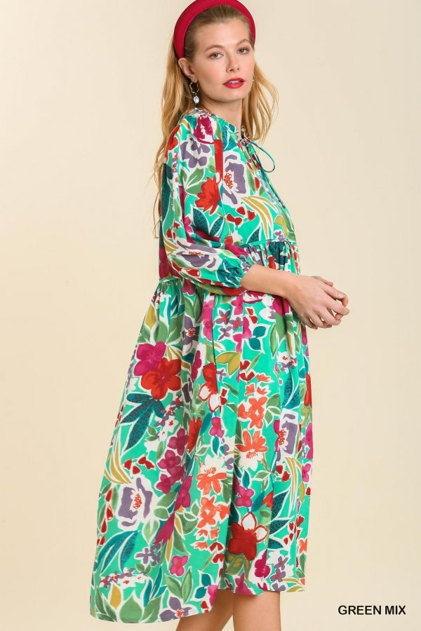 Model wearing a vibrant GREEN MULTI DRESS from Raggdoll Boutique, showcasing trendy coastal style and summer outfits.