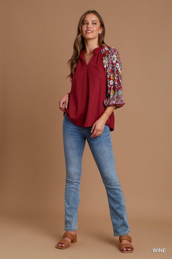 WINE AND FLORALS TOP featuring floral sleeves and trendy coastal style at Raggdoll Boutique.