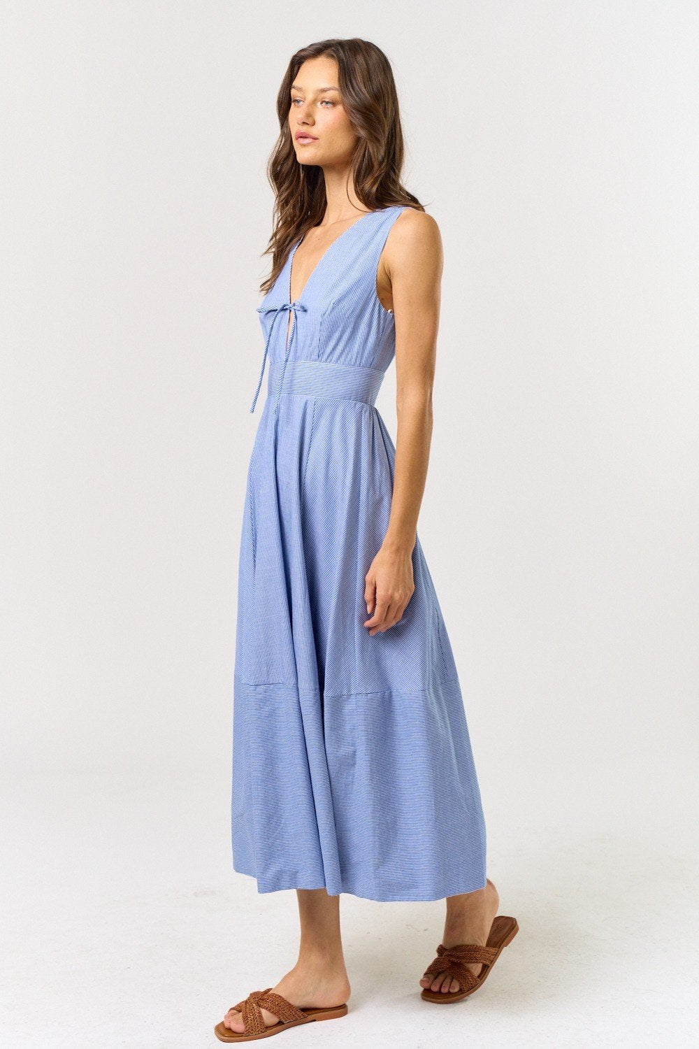 Blue & white sleeveless V-neck dress with front tie, perfect beach dress from a coastal boutique.
