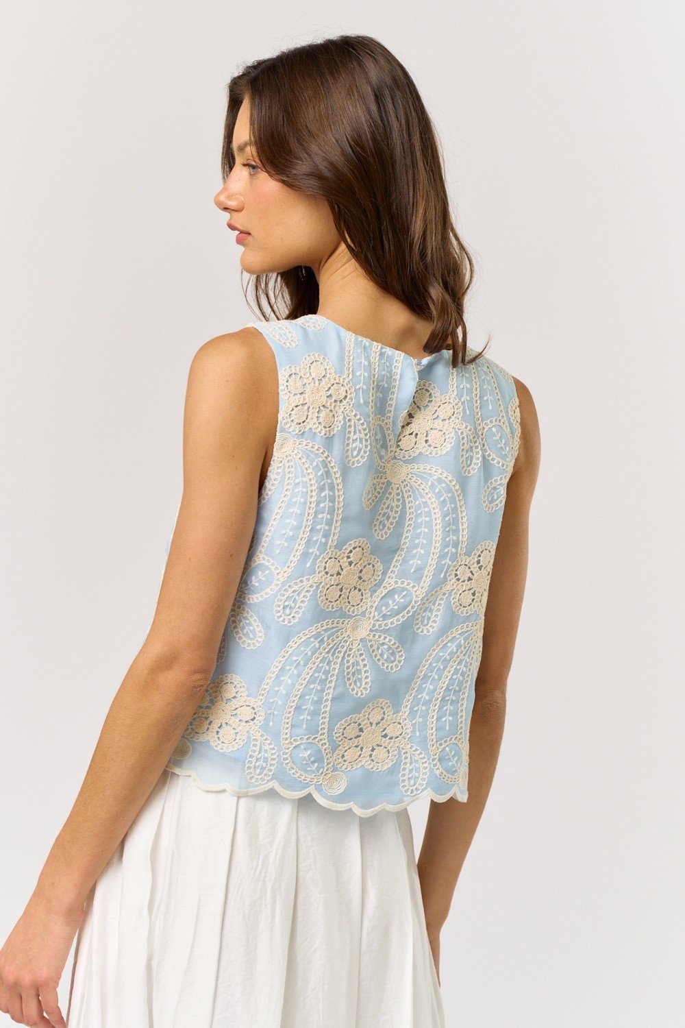Light blue sleeveless embroidered top, perfect for beach dresses or coastal boutique clothing, ideal for warm-weather styling.
