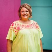 PLUS LIME SUNNY TOP worn by a smiling woman in front of colorful backgrounds, showcasing trendy coastal style.