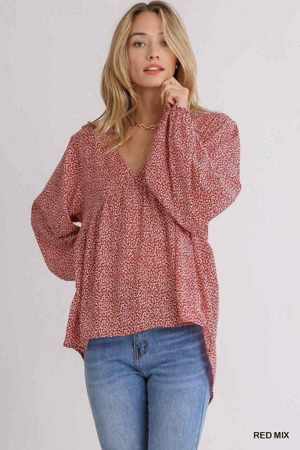 Woman wearing a trendy RED MIX ANIMAL PRINT TOP from Raggdoll Boutique, ideal for summer outfits Texas.