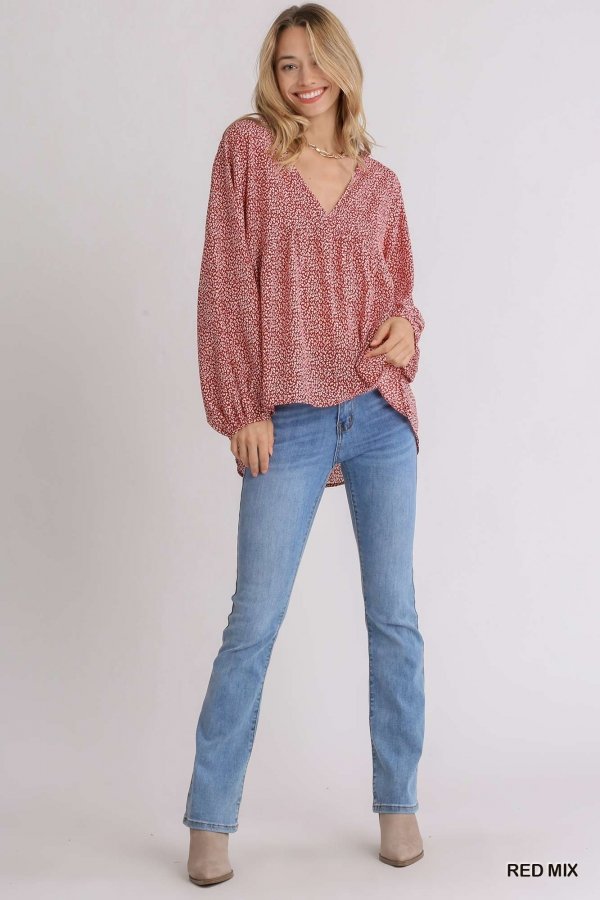 Model wearing a RED MIX ANIMAL PRINT TOP with blue jeans, showcasing trendy coastal style at Raggdoll Boutique.