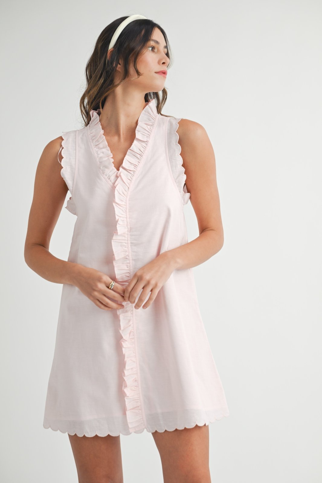 Light pink linen blend ruffle mini dress, perfect for coastal boutique clothing and tropical vacation styles.