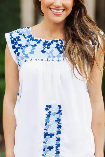 THE MARLA TOP from Raggdoll Boutique features blue floral embroidery, perfect for trendy coastal style and summer outfits Texas.