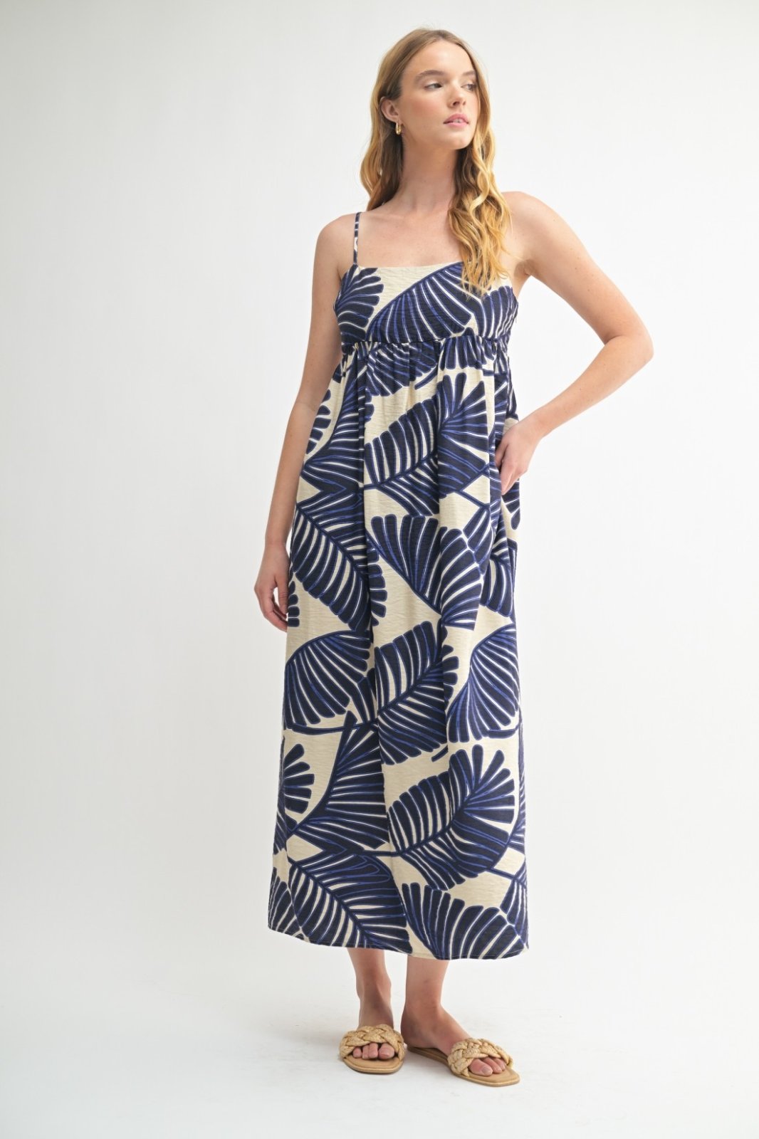 Blue and cream maxi dress with palm leaf pattern, perfect for beach outings and summer gatherings at coastal boutiques.