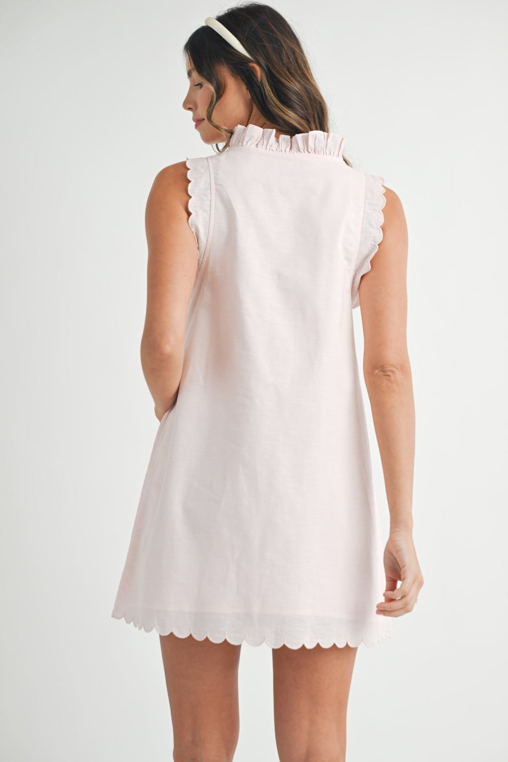 Light pink linen blend ruffle mini dress from Port Aransas boutique, perfect for coastal vacations and curated women's fashion.