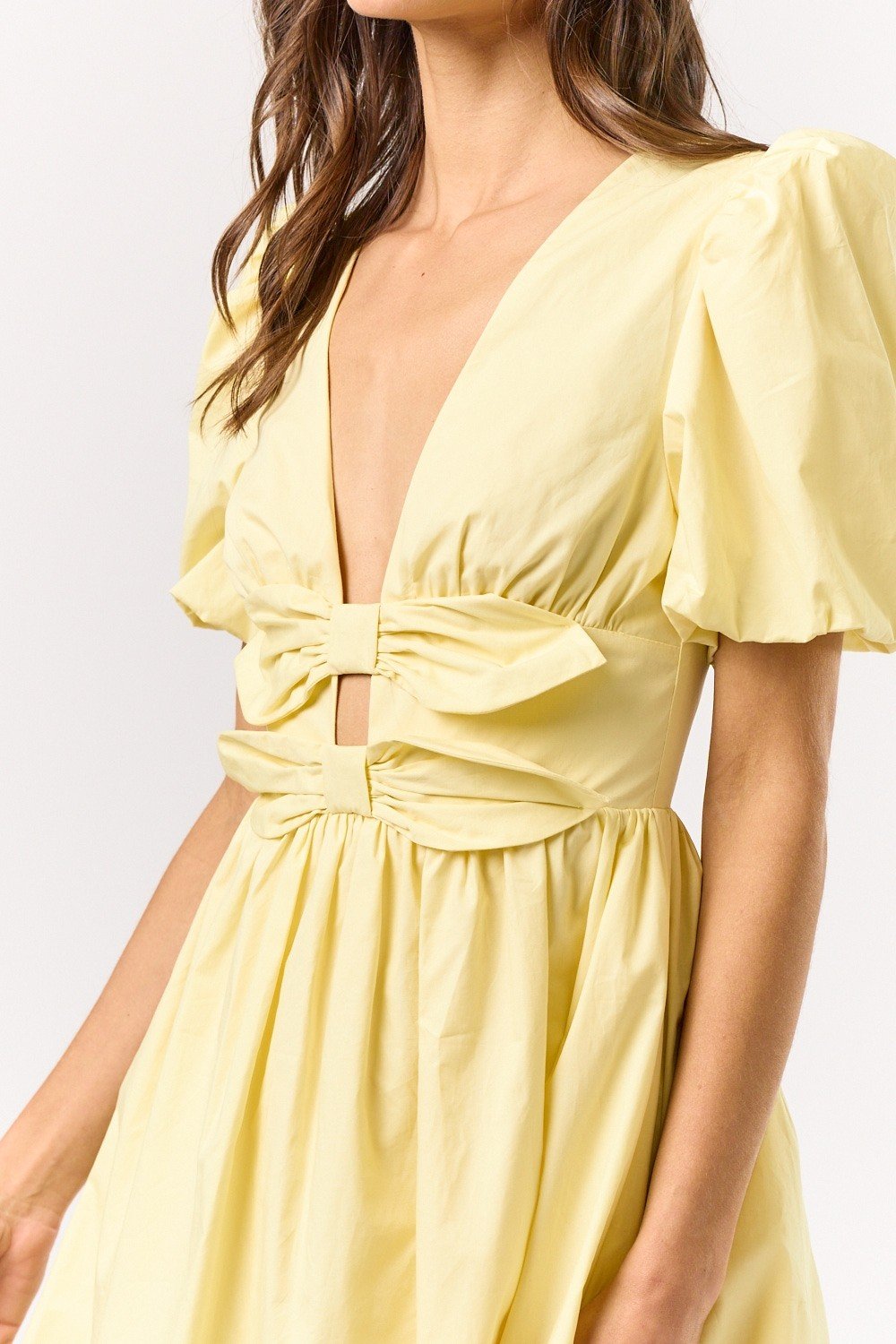 Melissa Dress featuring puff sleeves and bow detail, perfect for coastal boutique clothing and beach dresses.