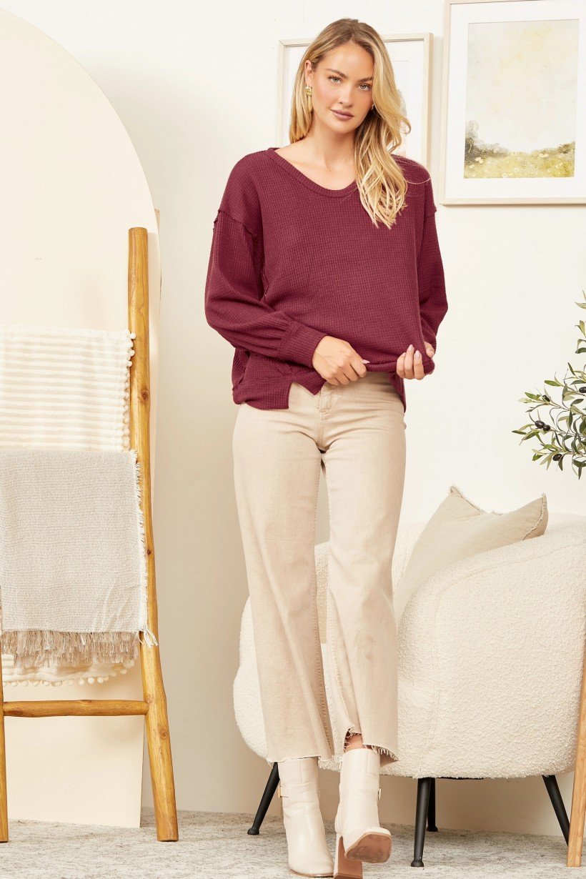 Wine Thermal Loose Fit Top styled with beige pants and boots, perfect for trendy coastal style at Raggdoll Boutique.