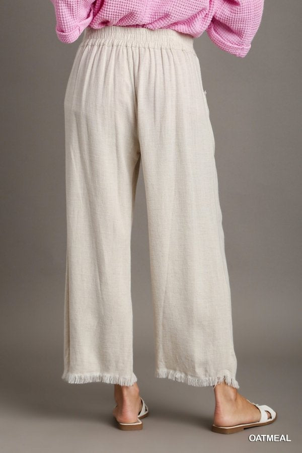 OATMEAL FRAYED HEM PANT-UMGEE displayed in a casual outfit, perfect for vacation wardrobe and trendy coastal style.