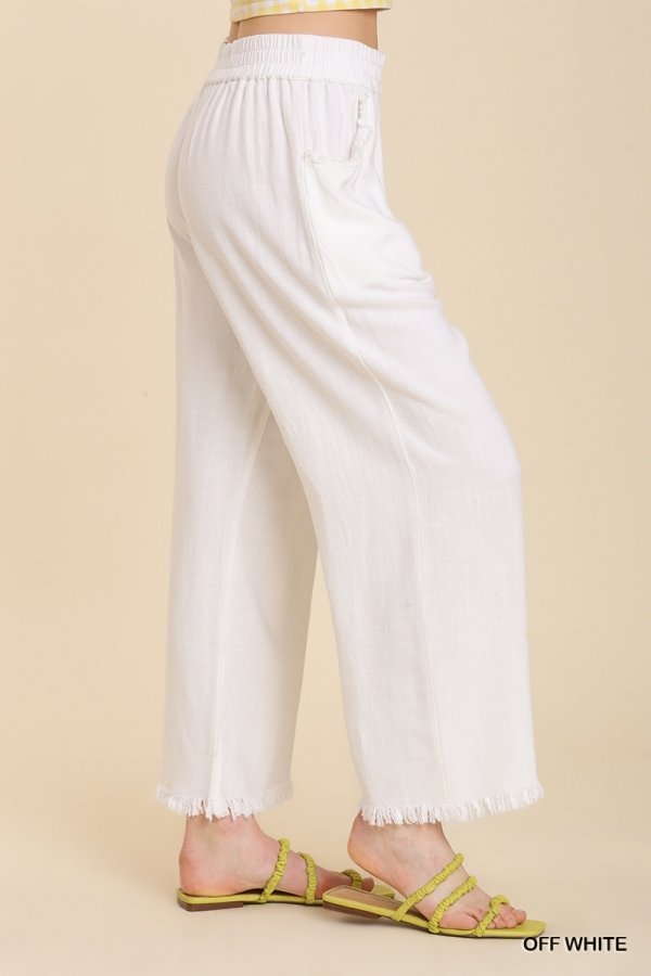WHITE FRAYED HEM PANT displayed on a model, showcasing trendy coastal style from Raggdoll Boutique.