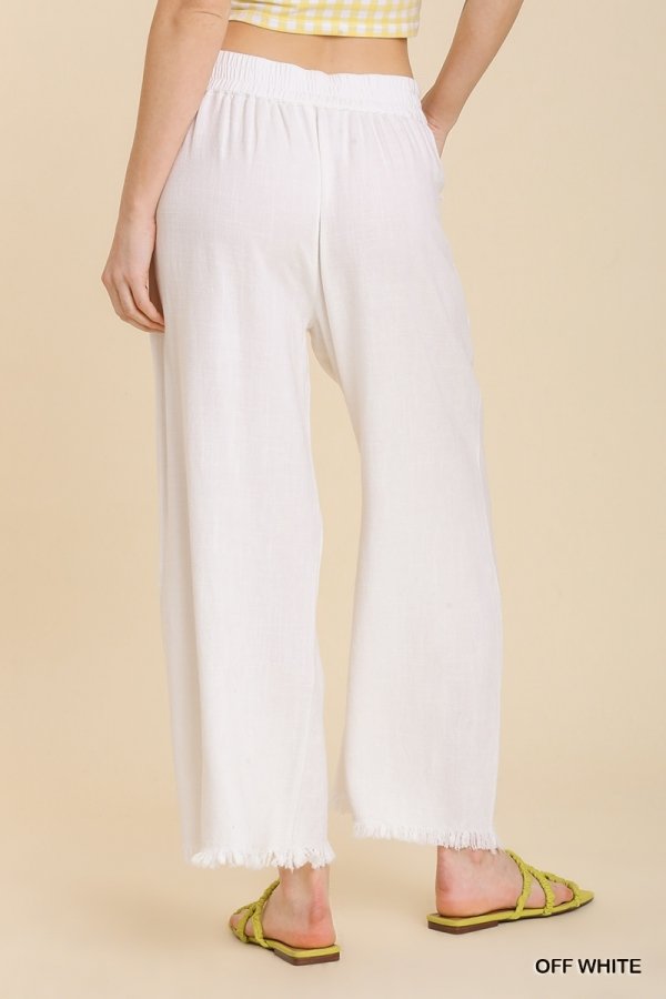 WHITE FRAYED HEM PANT showcased from the back, perfect for trendy coastal style from Raggdoll Boutique.