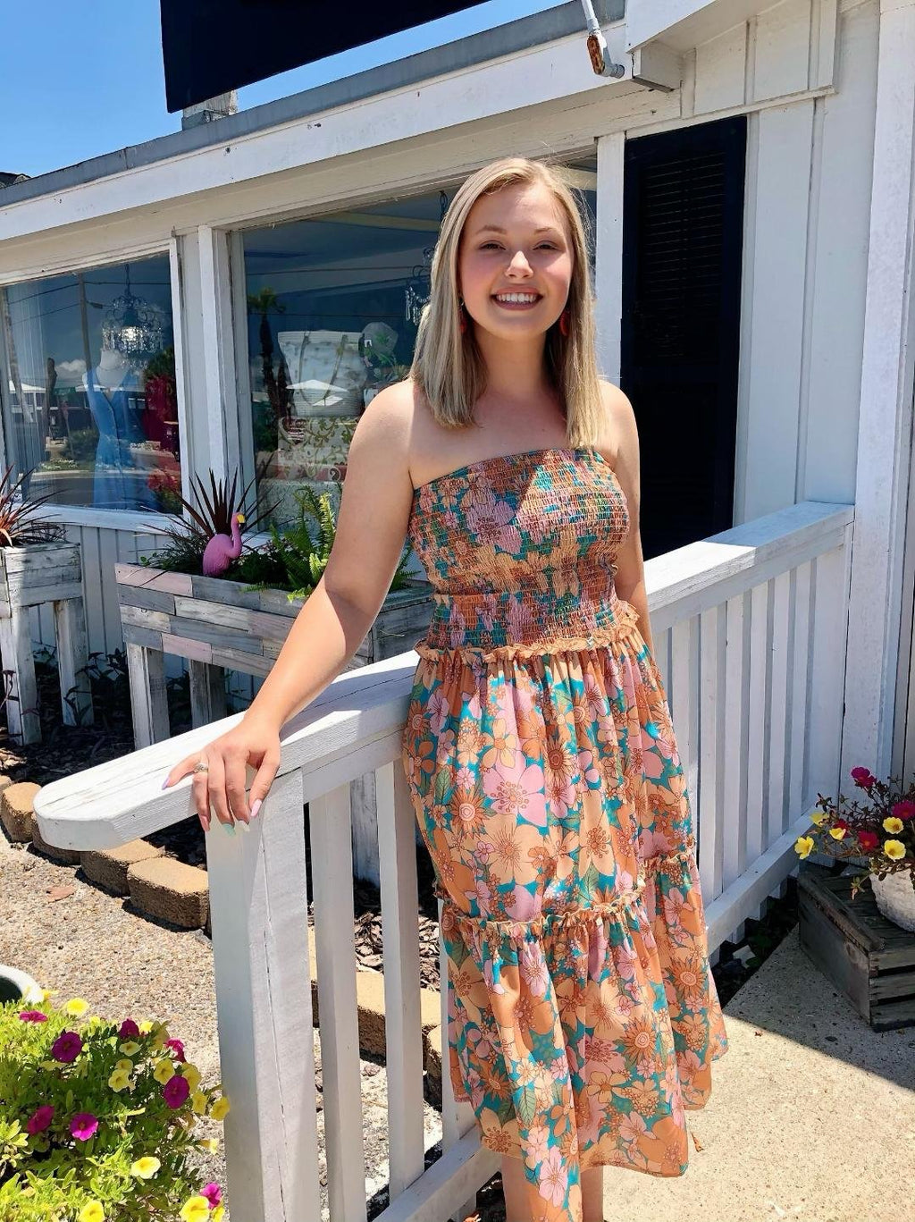 Model wearing OH, FLOWERS! SMOCKED TOP MIDI DRESS at Raggdoll Boutique in Port Aransas, showcasing trendy coastal style.