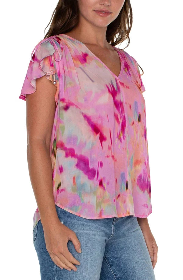 LIVERPOOL FUSHIA WATERCOLOR SHIRRED TOP showcasing vibrant colors and a stylish shirred back, available at Raggdoll Boutique.