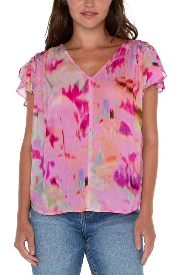 LIVERPOOL FUSHIA WATERCOLOR SHIRRED TOP featuring a V-neckline and flirty petal sleeves, available at Raggdoll Boutique.